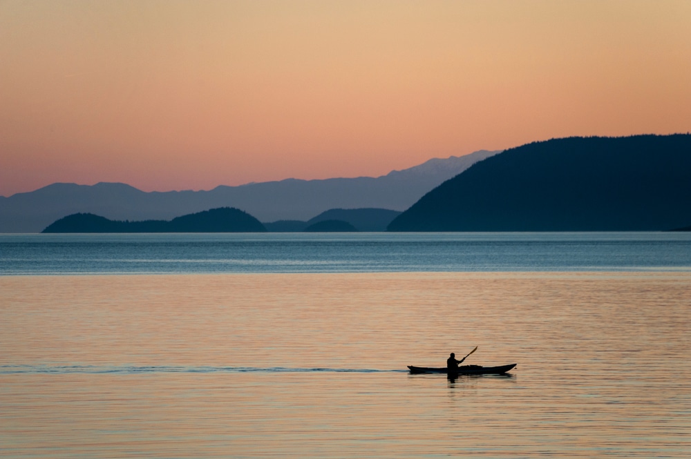 Kayaking at sunset is one of the best San Juan Island Things to do