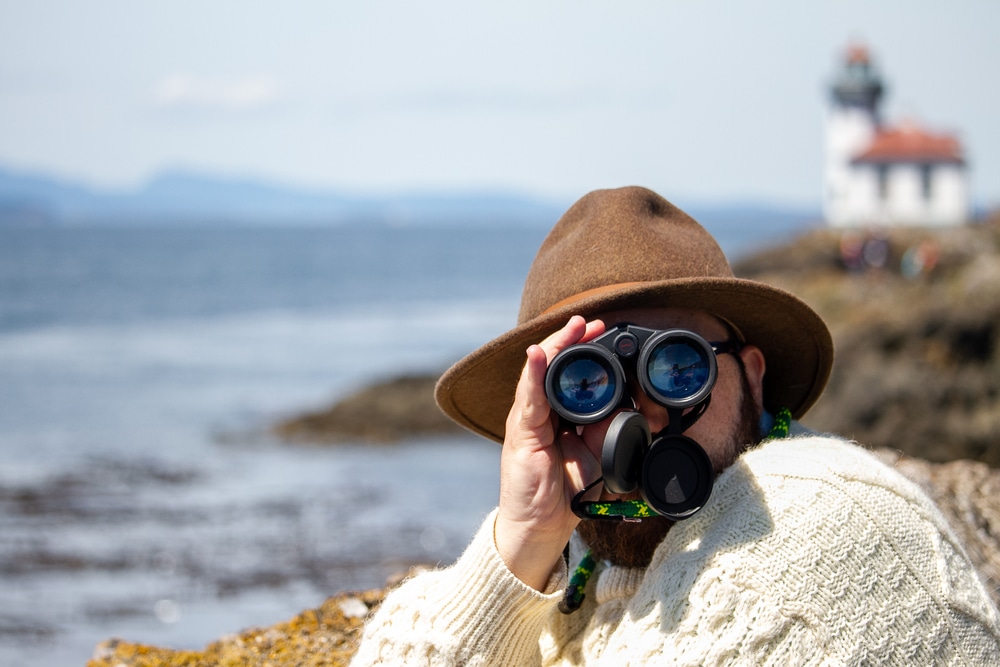 Man wearing a hat and enjoying whale watching and more at Lime Kiln State Park