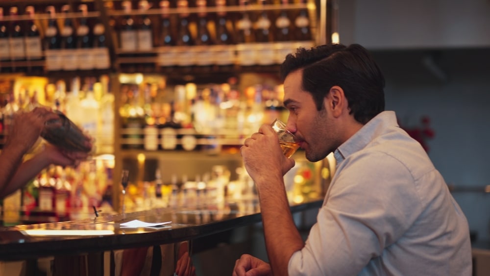 man enjoying an old fashioned at one of the many Midwest Supper Clubs near