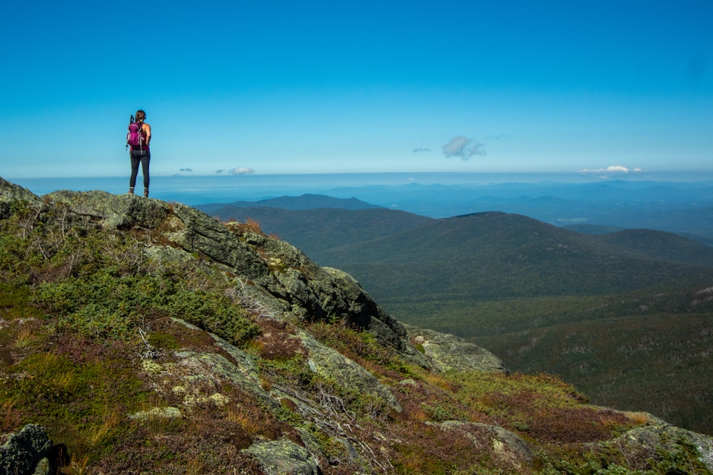 Hiker at the top of the Mount Washington Hike taking in the view