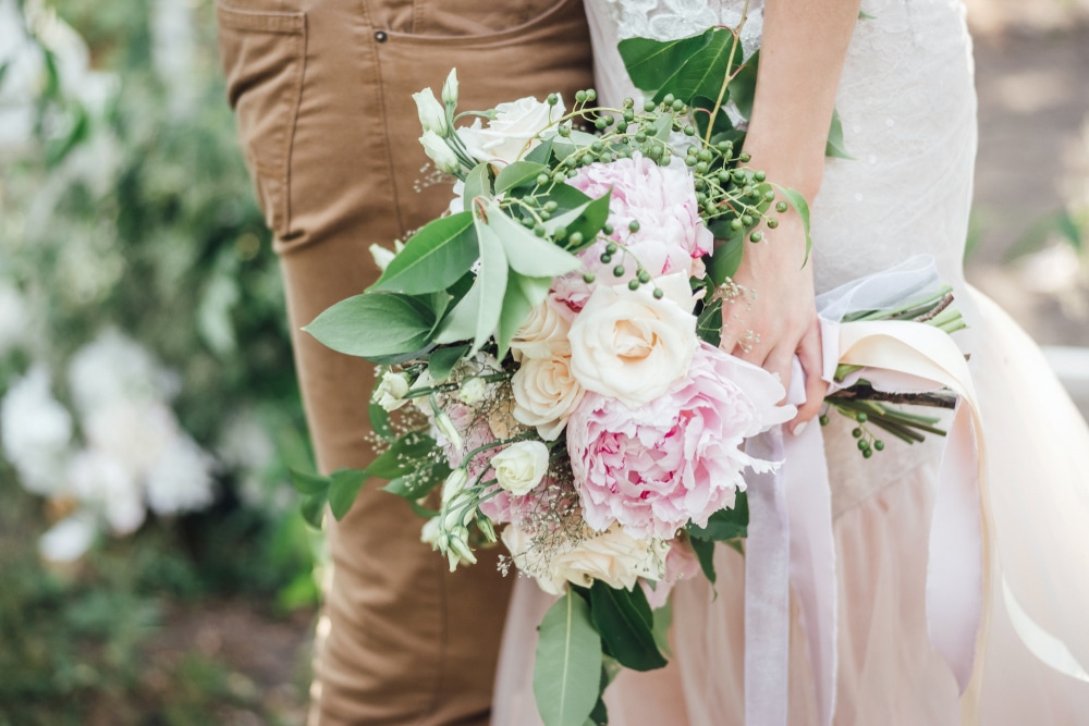 focus on a couple with bridal bouquet. Discover unique wedding venues and the best places to get married in the Midwest.