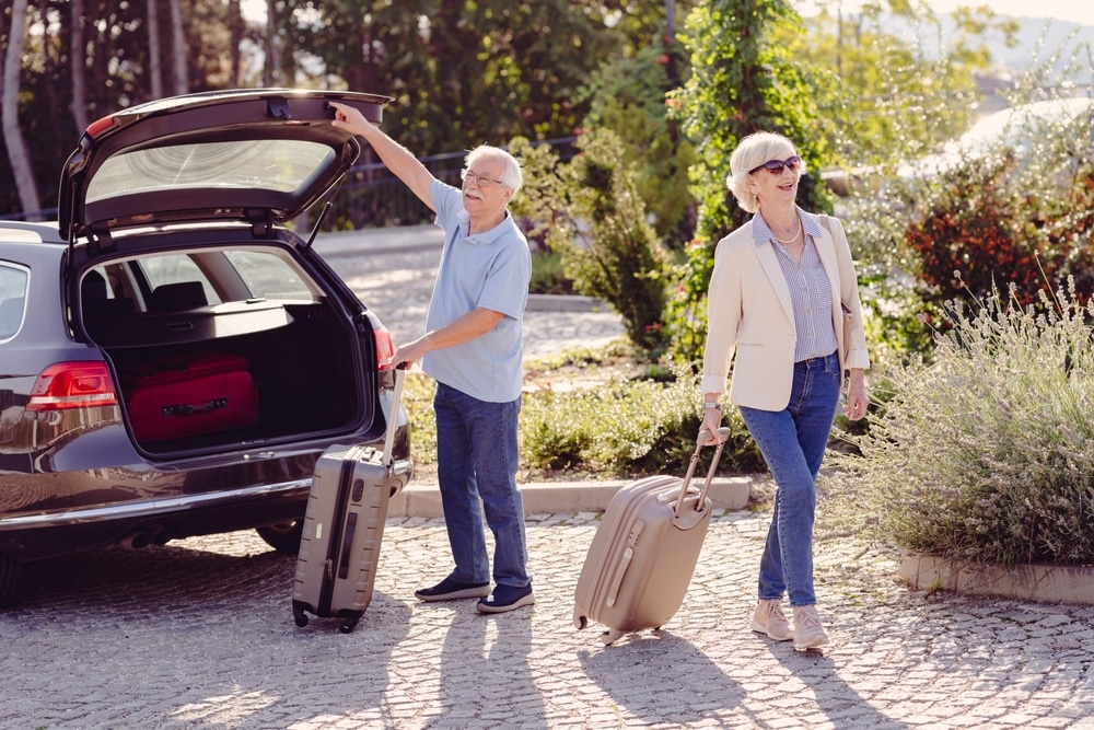 Couple taking luggage out of their car as the enjoy the best weekend trips from Minneapolis