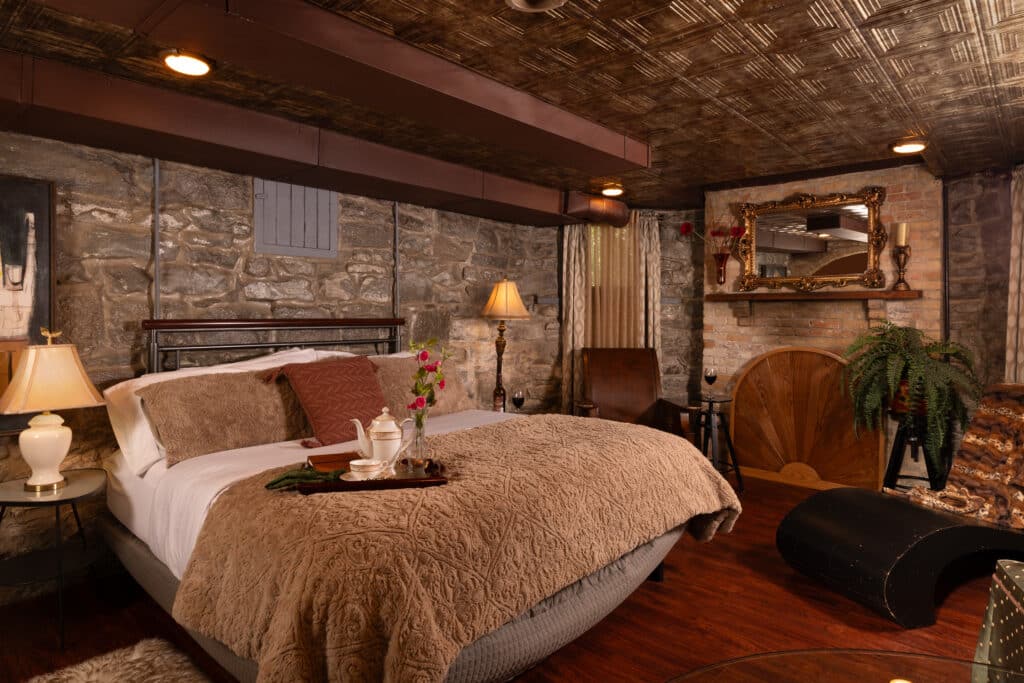 A king bed with luxurious linens in The Keep Room at the Historic Webster Inn, the best Bed and Breakfast in Michigan.