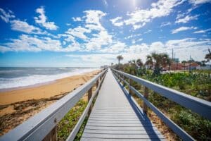The best time to visit Florida is now. Walk the gorgeous Flagler Beach boardwalk and see the cinnamon sand.
