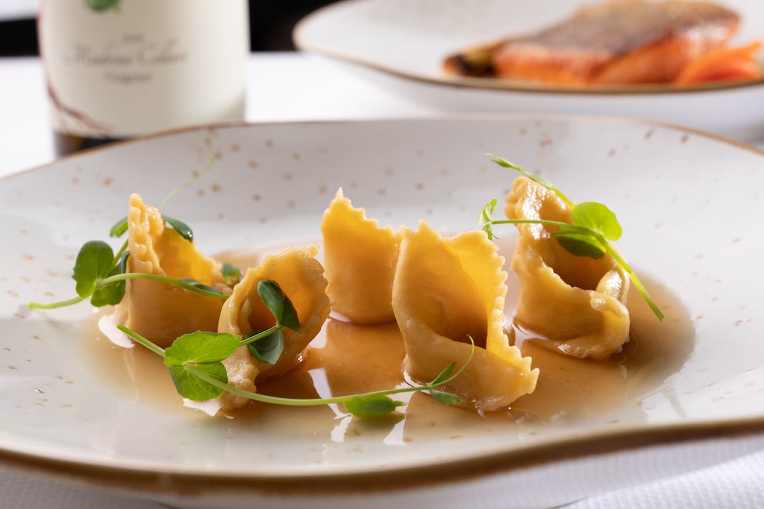Plate of pasta and green herbs on a plate
