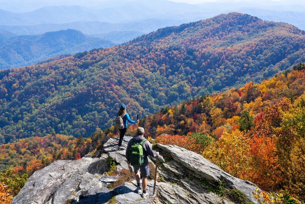 Couple hiking through some of the best Western North Carolina fall foliage