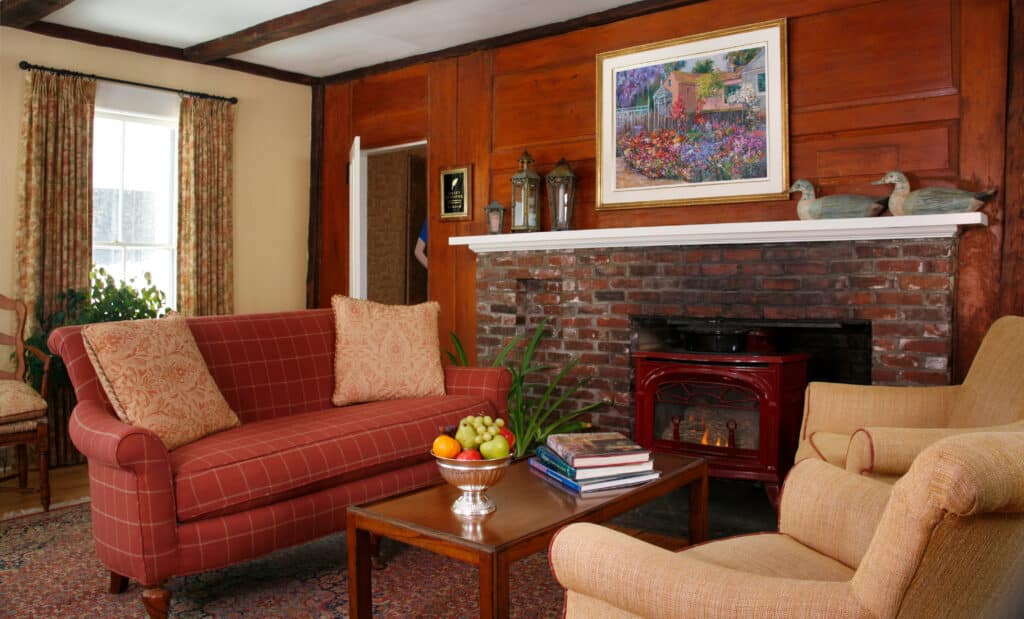 One of the Best New Hampshire Inns. Sugar Hill Inn entryway. Fireplace and two couches.