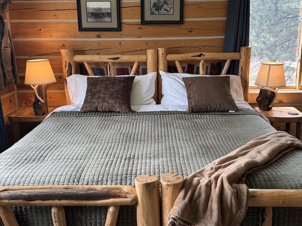 Check out lodging near Missoula, wooden bed frame with green comforter and white and brown pillows