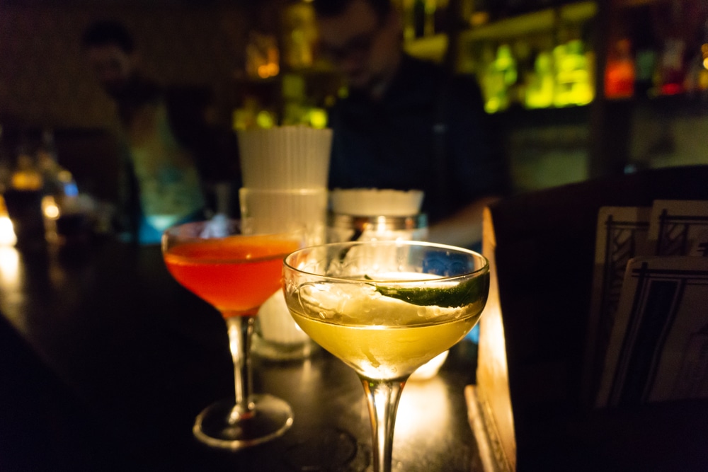 Two cocktails sit on the bar in a speakeasy in Kansas City, one of the most unique places to stay.