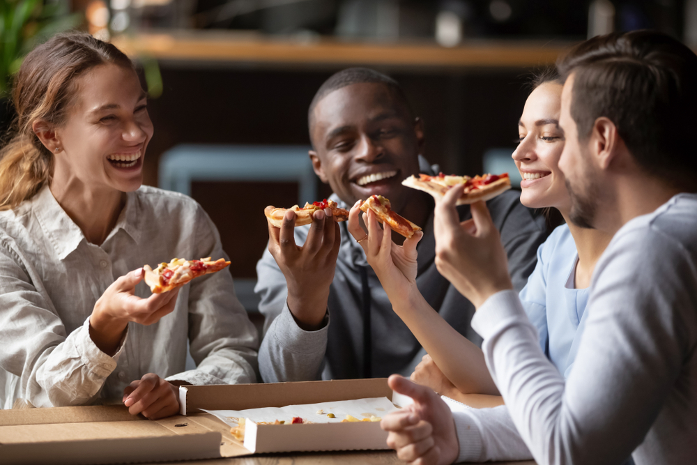 Friends enjoying pizza at the best Stevenson, WA Restaurants