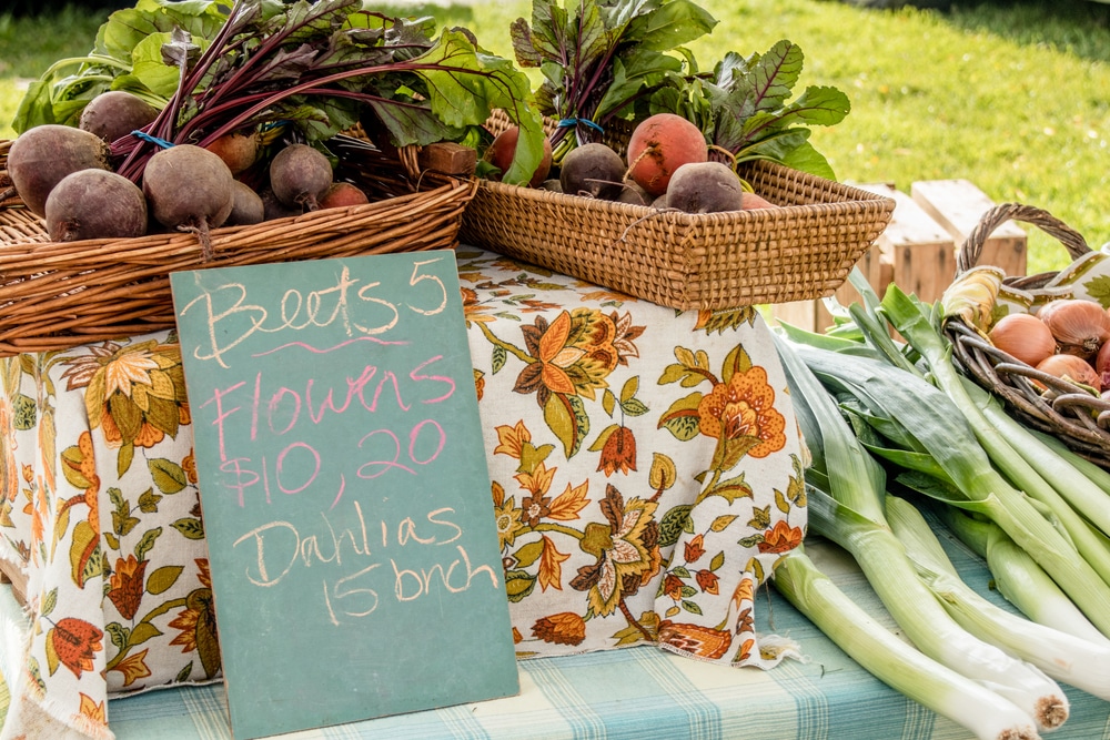 A sign for vegetables and flowers at Bainbridge Island Farmers' Market in Winslow on Bainbridge Island.