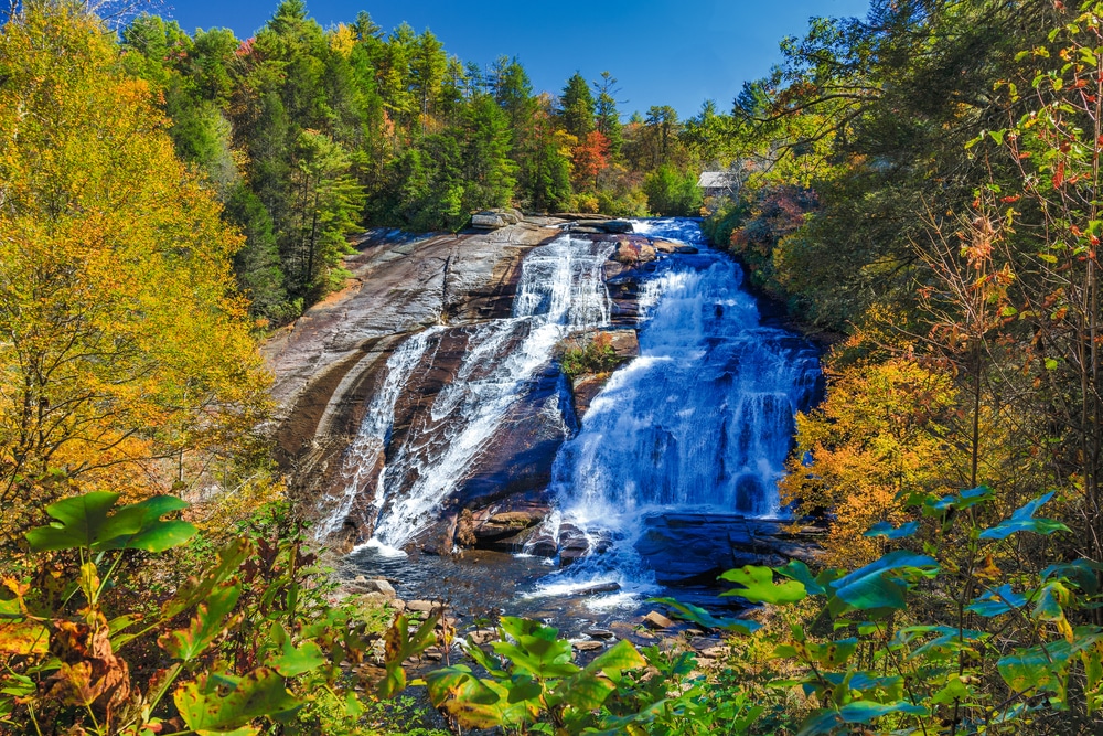 Visit Dupont State Recreational Forest to see the spectacular waterfalls, like High Falls. Image of High Falls in autumn.