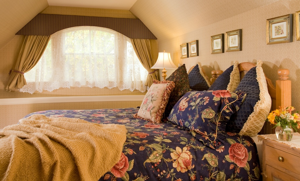 Enjoy one of the best weekend getaways in Maine at our Maine Bed and Breakfast. Bed with navy blue floral bedding.