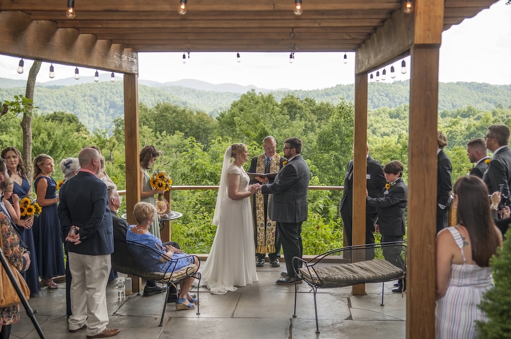 Micro wedding packages NC are the best way to enjoy your big day! A couple getting married with a small group of onlookers.