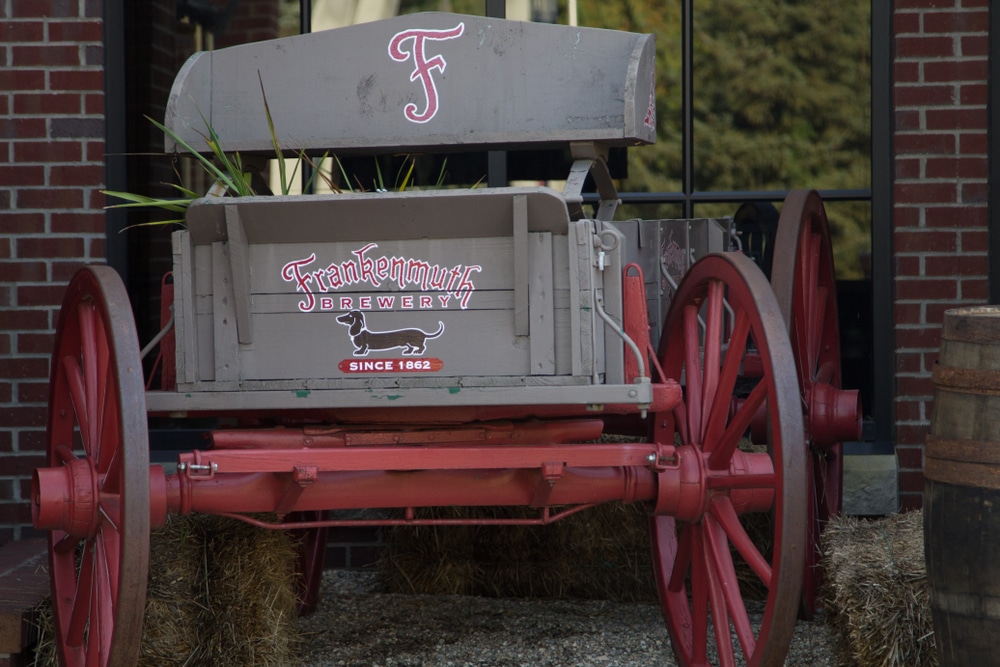 A wooden wagon outside Frankenmuth Brewery, with their signature dachshund logo.