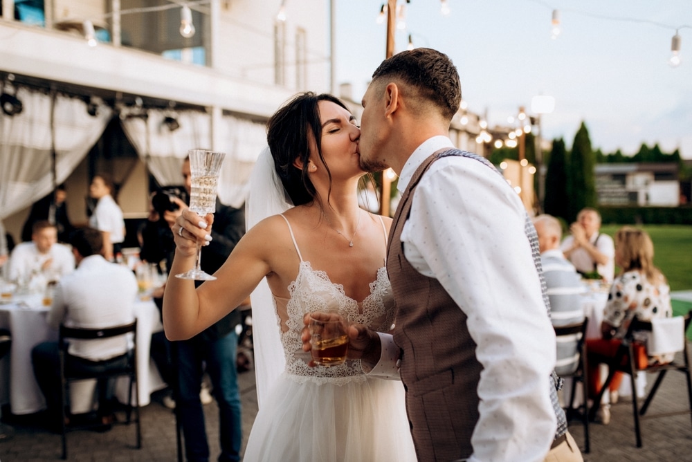 Couple kissing in front of unique wedding venues