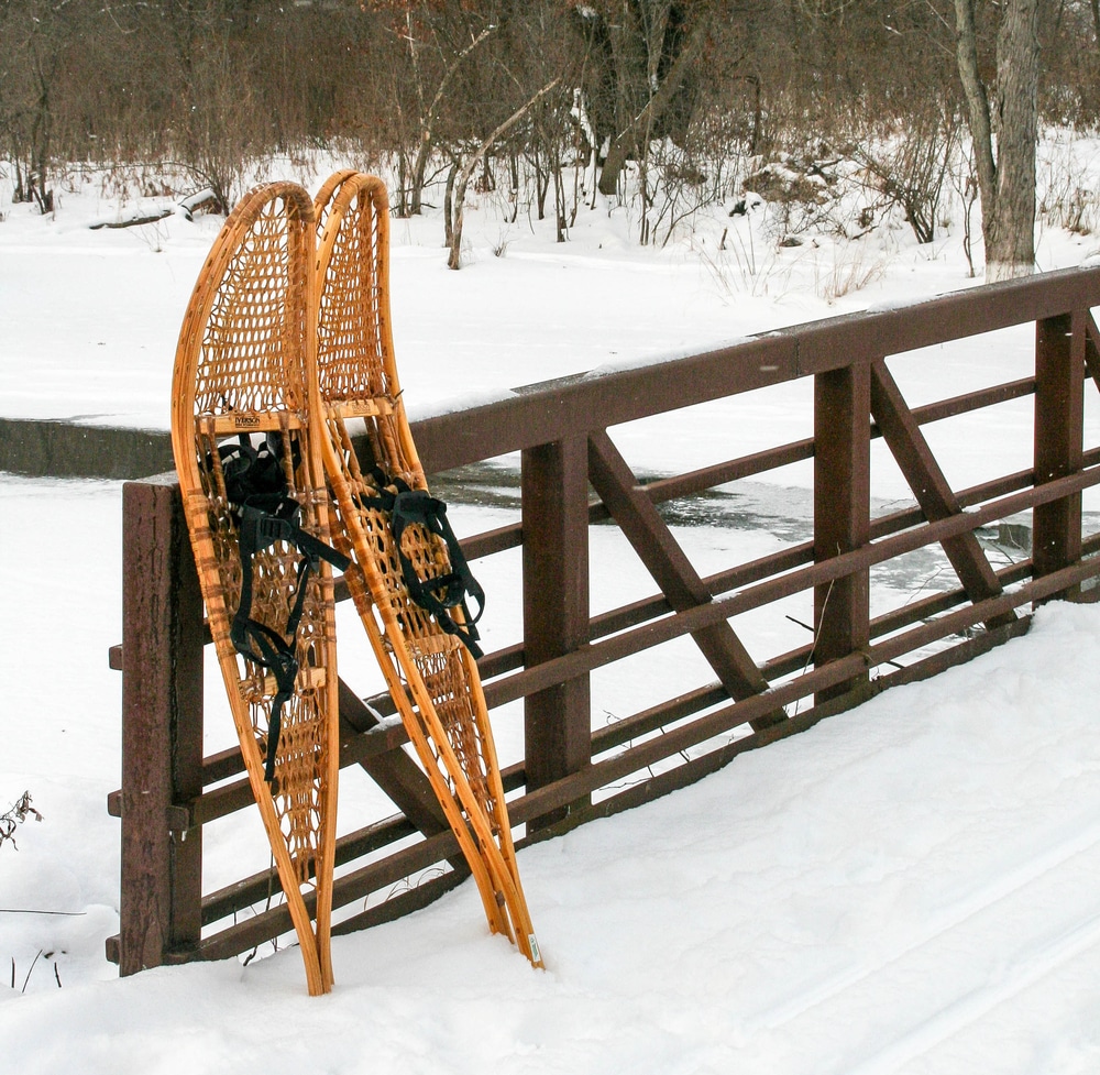 Wooden Snowshoes against fence. Snowshoeing is one of the best things to do in Lassen during the snowy winter.
