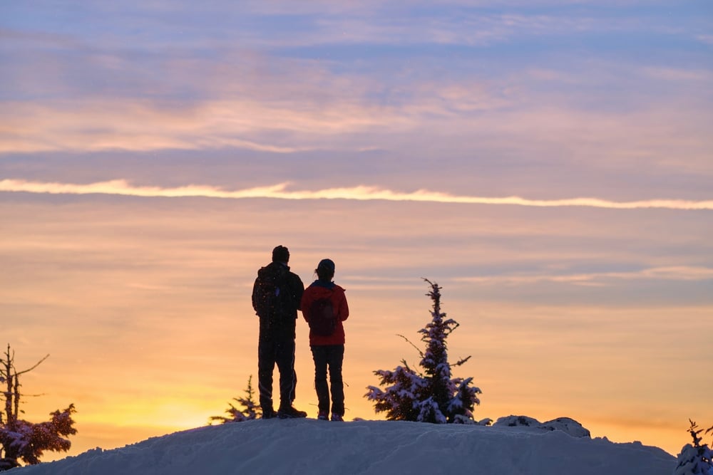 Couple enjoying winter views while snowshoeing, another top choice of winter activities in Michigan