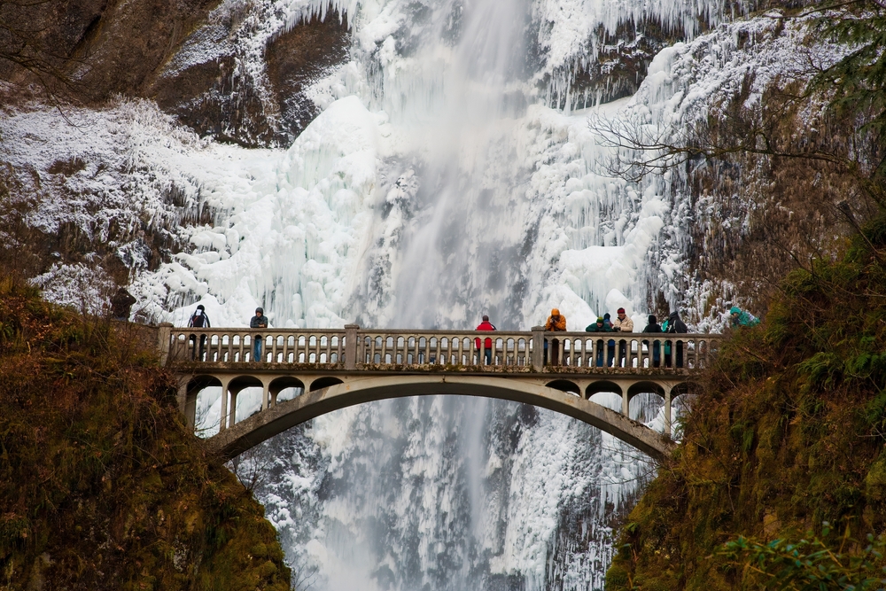 people enjoying Multnomah falls in winter, one of the best things to do in the Columbia River Gorge near our Cabins