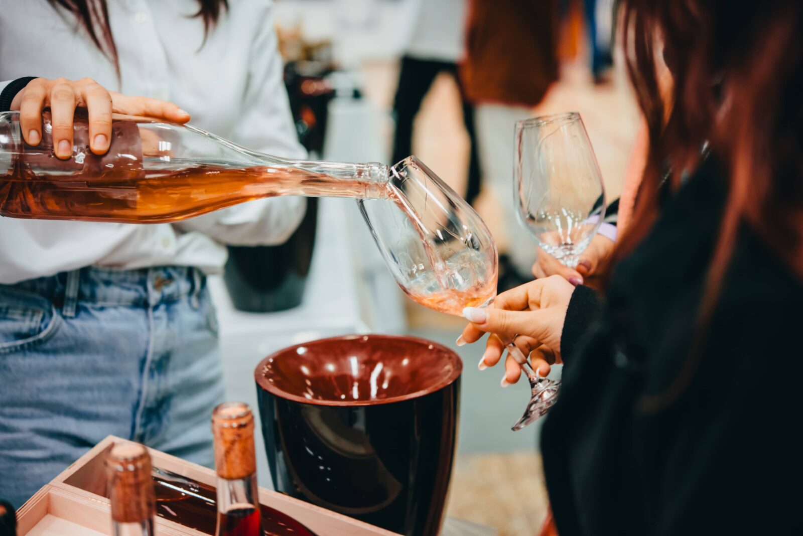 Explore the best Cayuga Lake wineries along the Cayuga Lake Wine Trail. Photo of a woman wine tasting rose