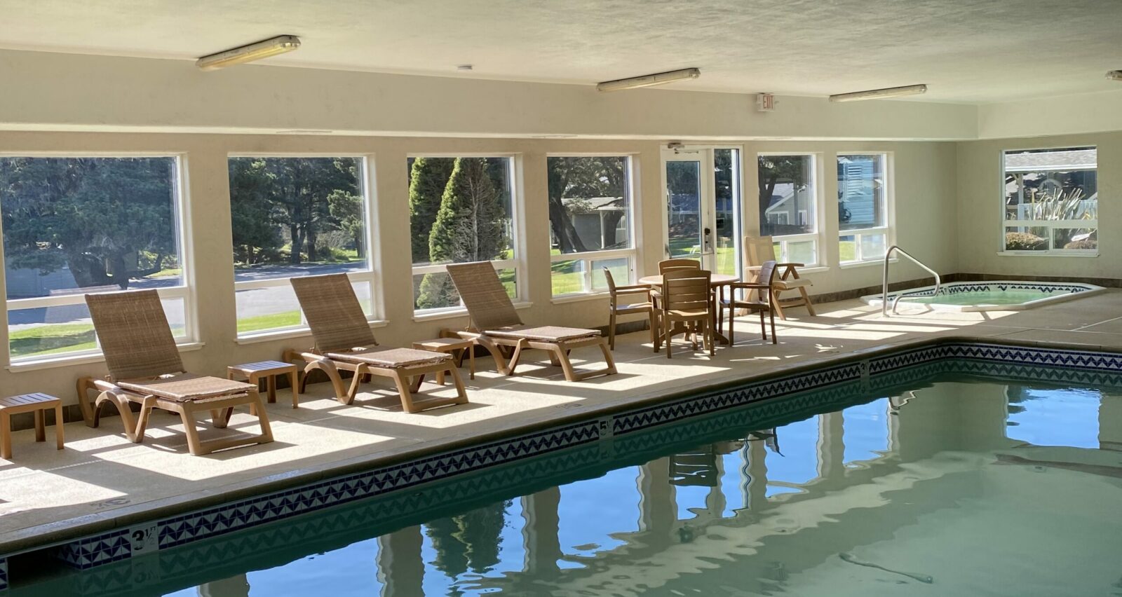 The indoor pool and hot tub with lounge chairs at one of the best places to stay on the Oregon Coast.