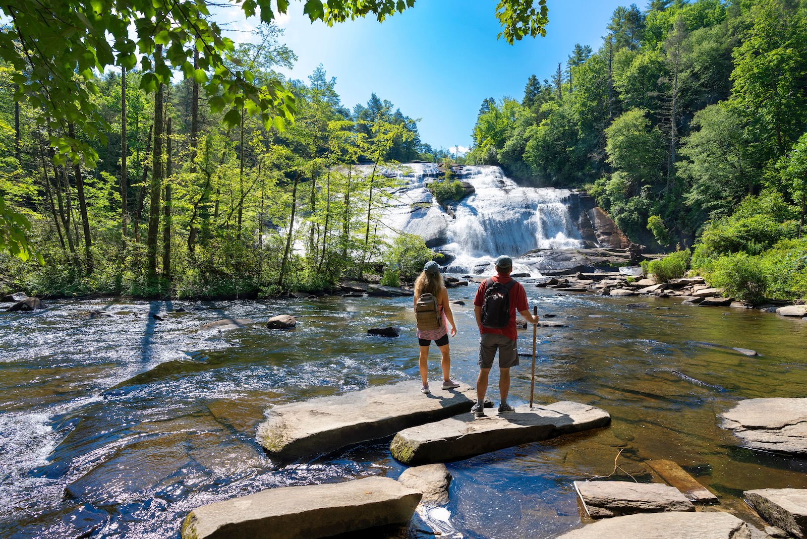 Couple hiking to a waterfall, one of the best things to do in Western North Carolina