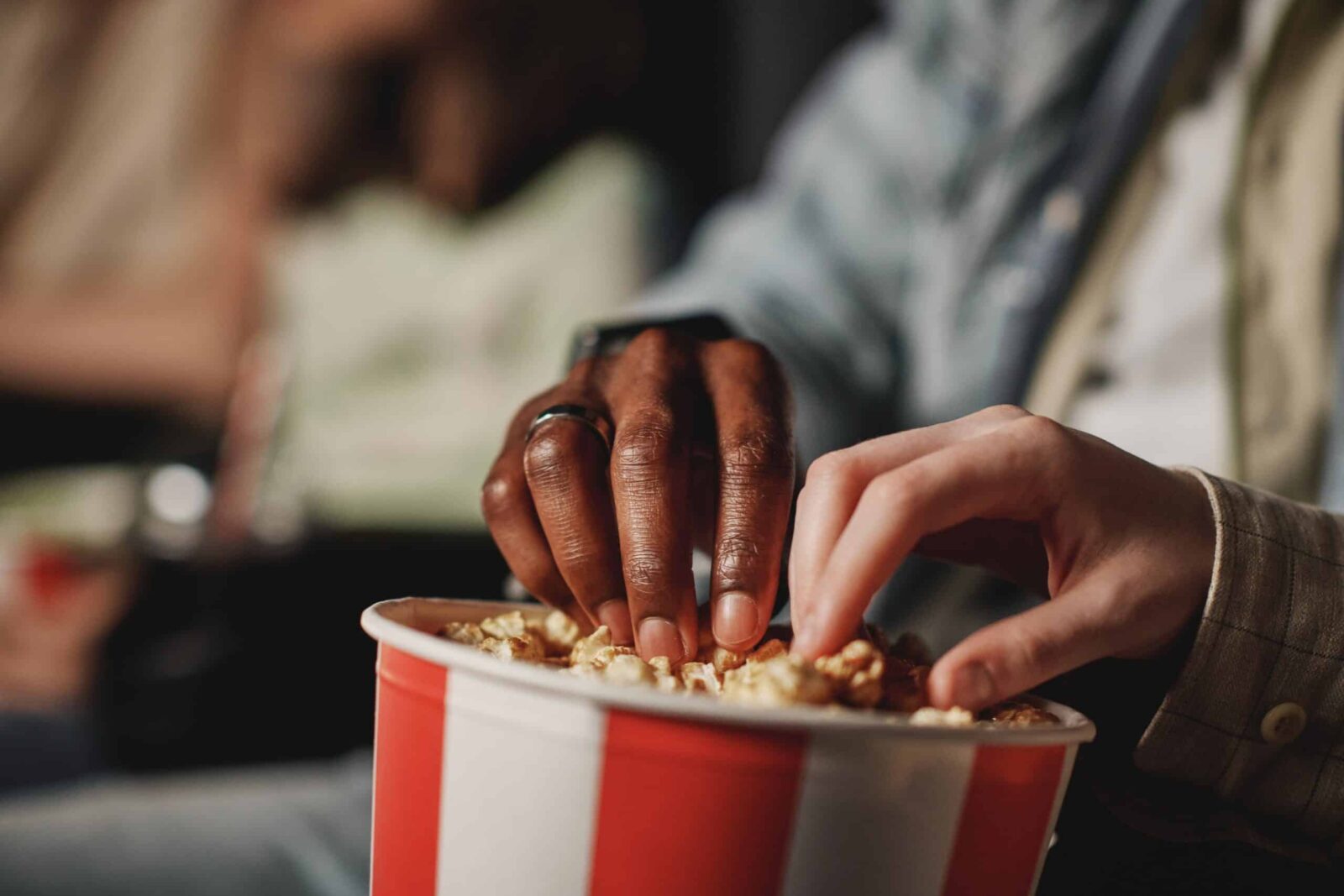 Close up photo of two hands and popcorn bucket at Latchis Theater.