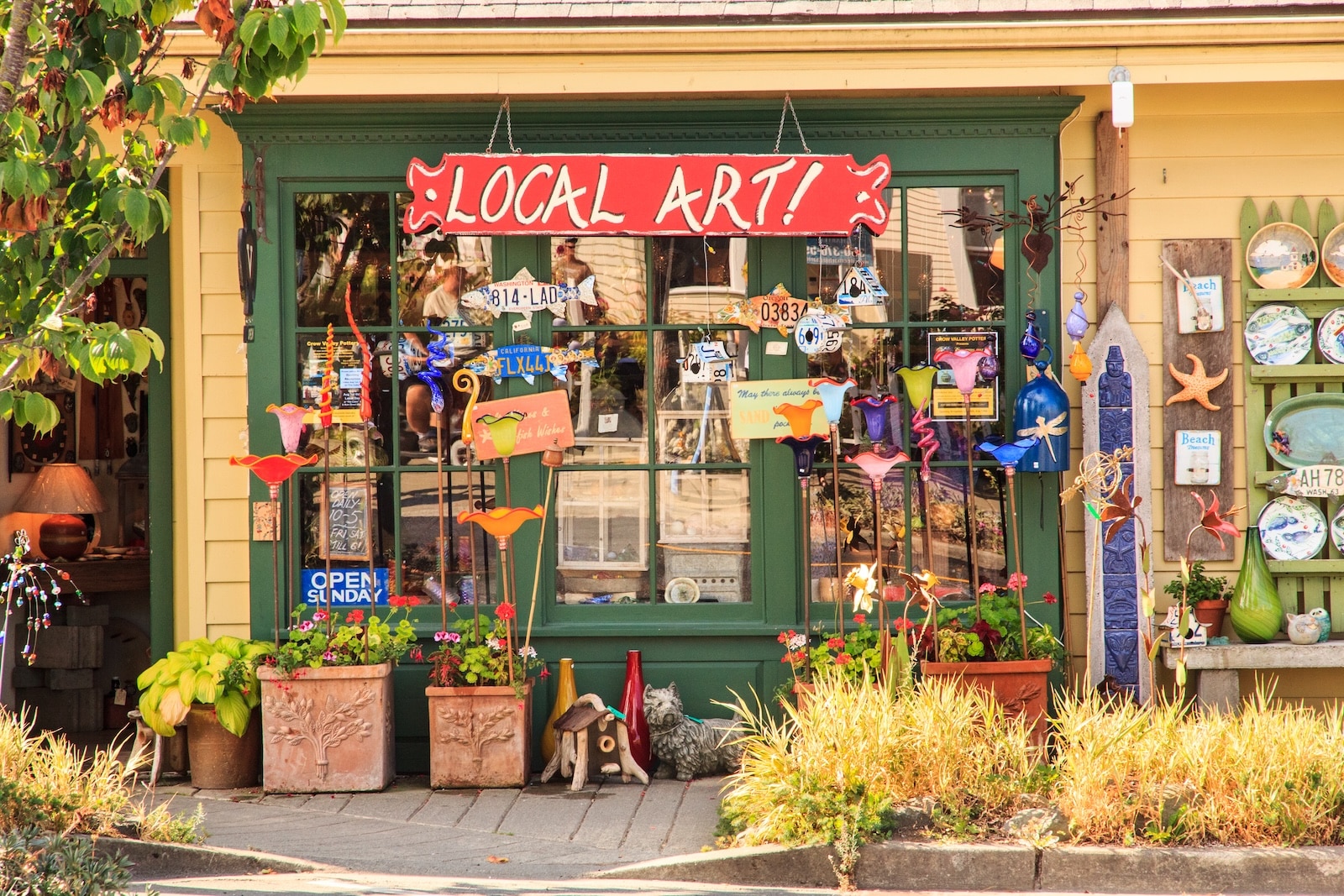 There are many things to do on Orcas Island and shopping is just one of them. green and yellow storefront featuring a variety of hand painted signs
