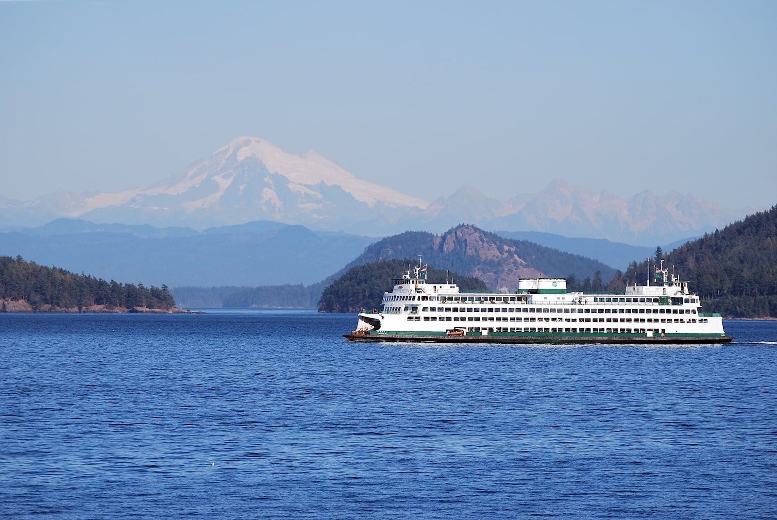 San Juan Island Ferry traveling through the water, mountains in the background