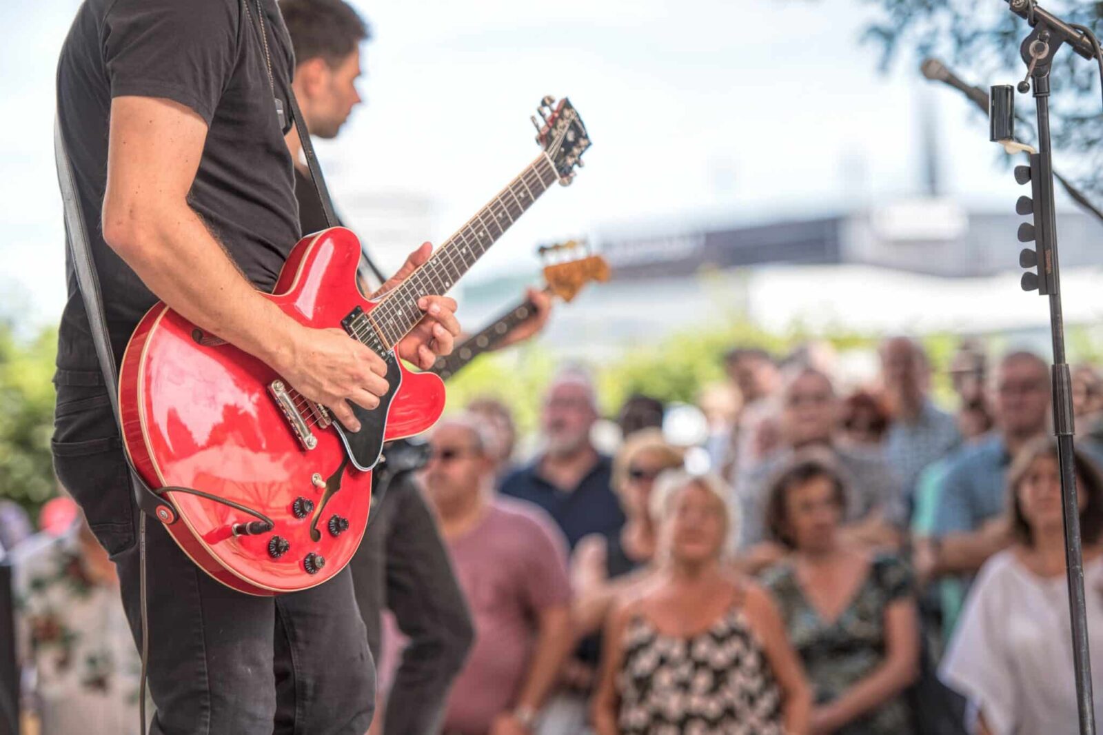 Guitarist performing in concert at First Financial Amphitheater in ABQ.