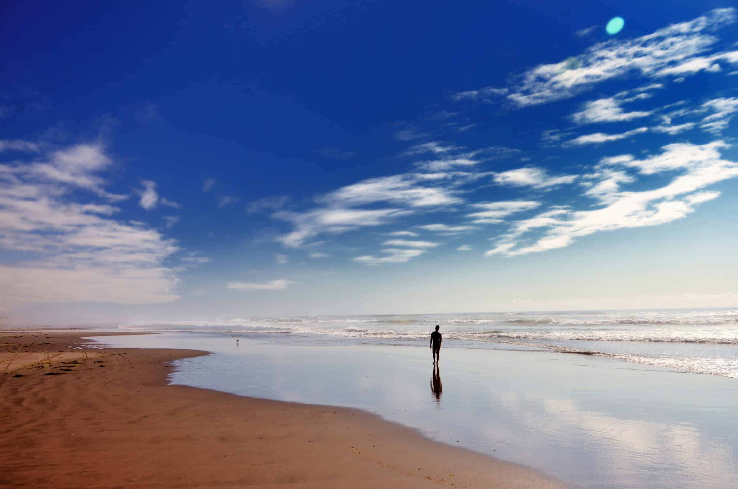 Person walking Whiskey Run Beach, one of the best Oregon Beaches near Bandon.