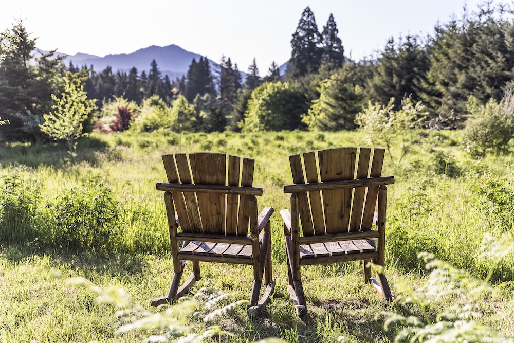 Two chairs overlooking the property at our luxury cabins in WAshington State, a great place to unwind after driving the Hood River Fruit Loop