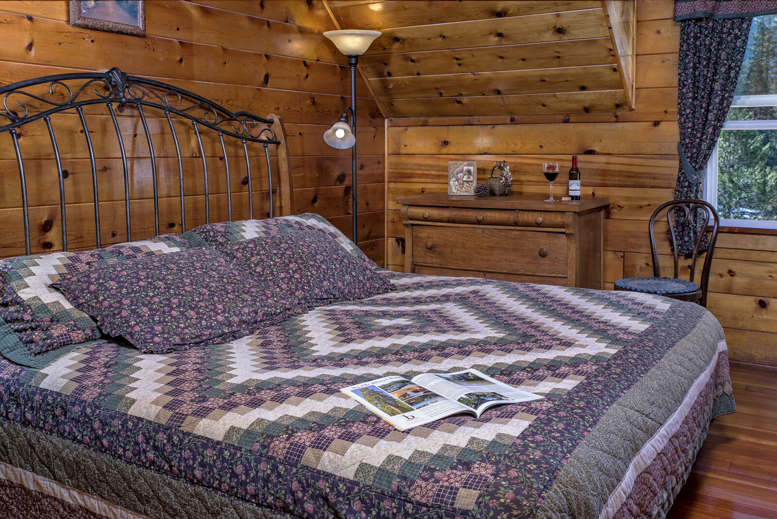 Knotty pine walls, bed with patchwork quilt in the Evergreen Room at St Bernard Lodge, a great option for Lassen National Park lodging.