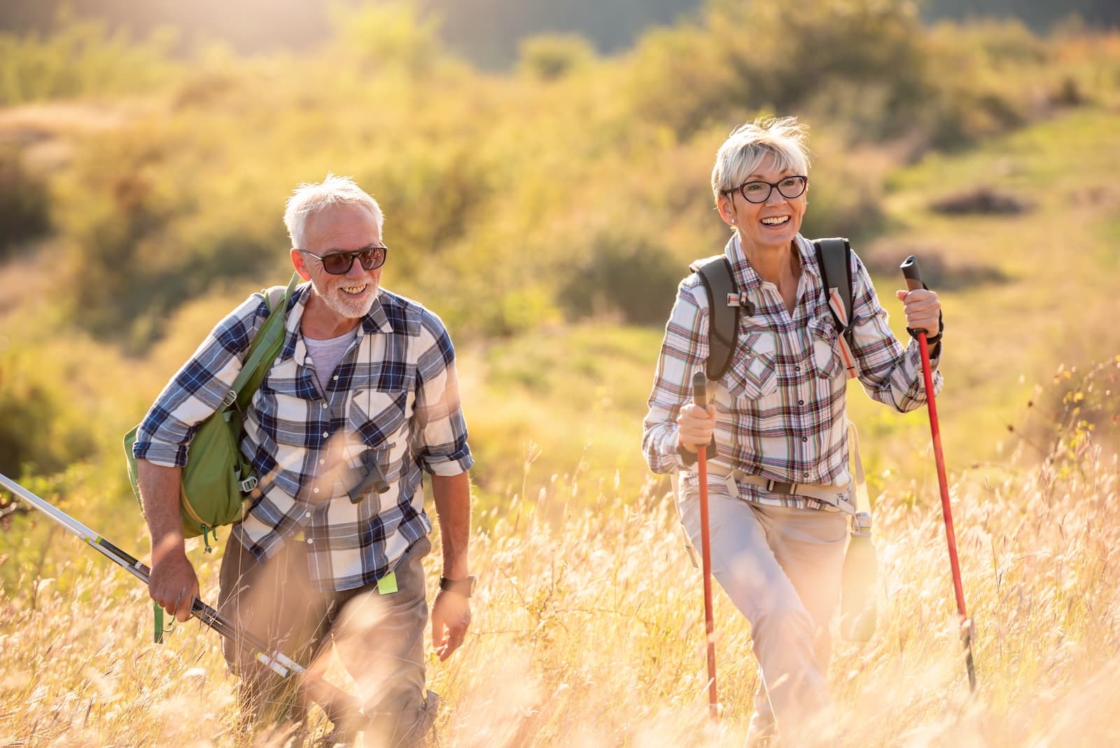 Active senior couple hiking out to the Cattle Point lighthouse on a sunny day