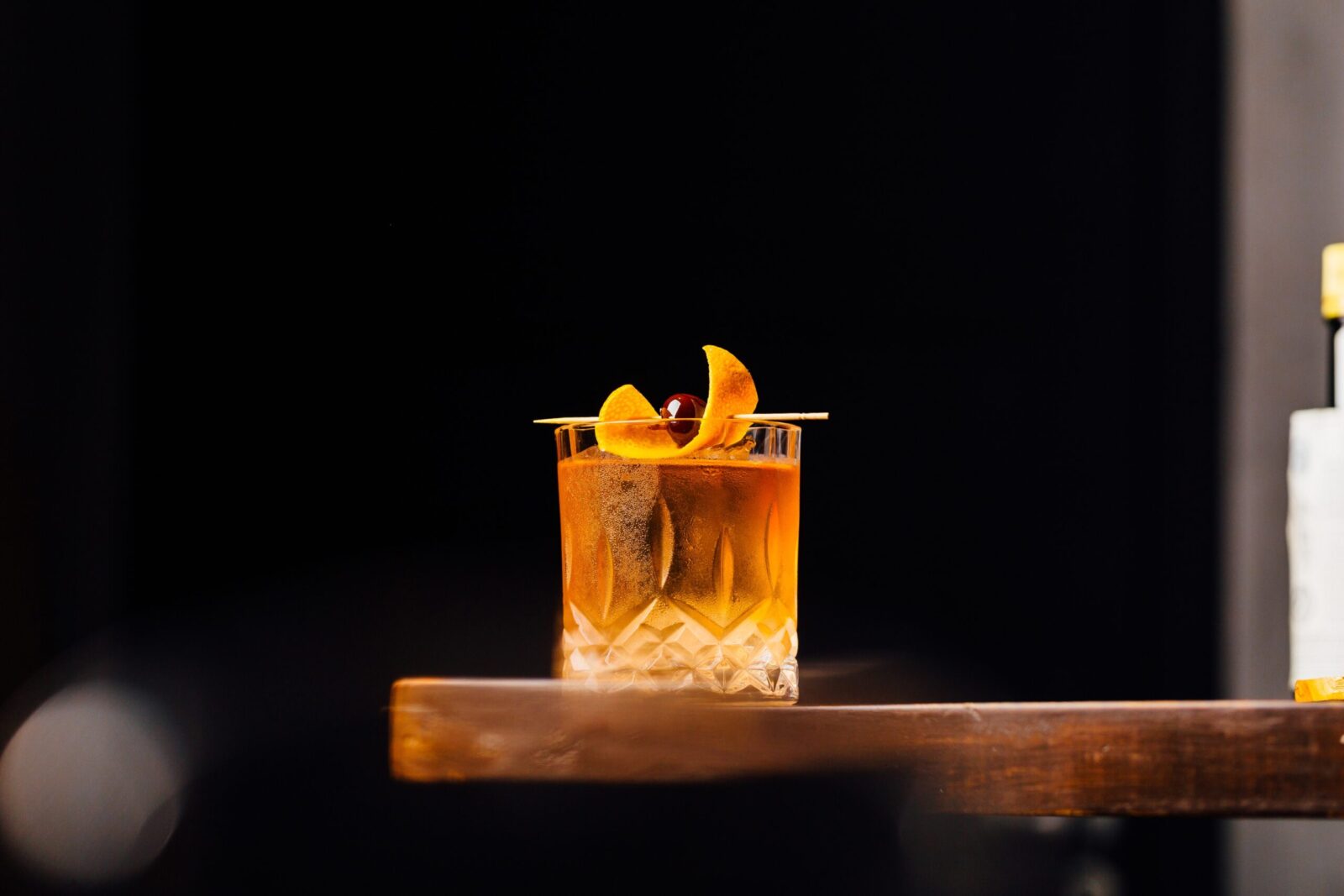 Enjoy a classic Old Fashioned at a Wisconsin Supper Club, on the rocks, with orange peel and cherry garnish.