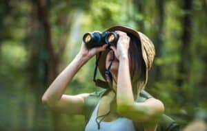 Women with binoculars birding in the Delta National Forest.