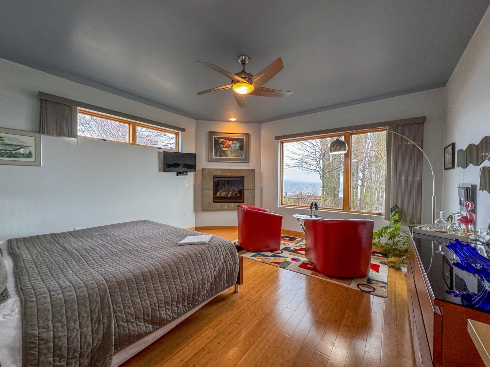 The Aerial Lift Birdge Suite with bed, lake view, fire place and seating area at our Duluth Bed and Breakfast