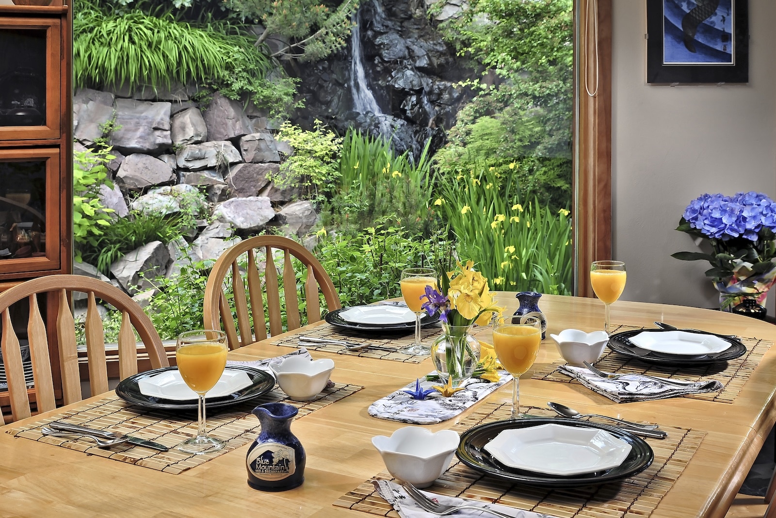 A table set for breakfast in front of open doors with a garden at the best Montana Bed and Breakfast.