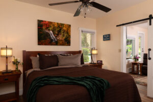 Bedroom in the Innkeepers Flat at Lake Pointe Inn, with rich burgundy bedding