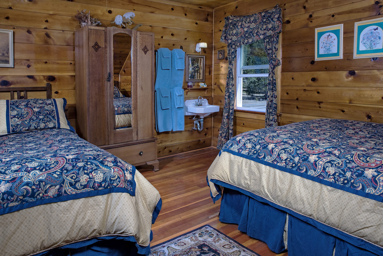 The Sunrise Room at our Mineral CA Hotel has two beds and sink. 