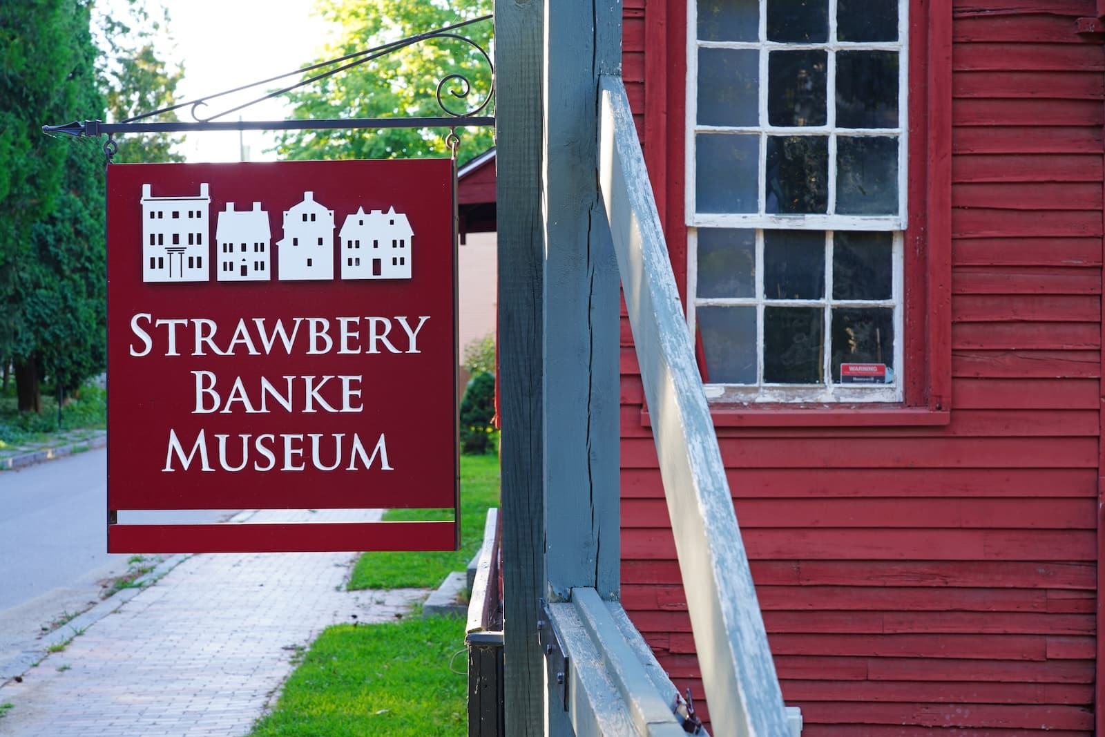 A red building with a red sign, showcasing the Strawberry Banke Museum.