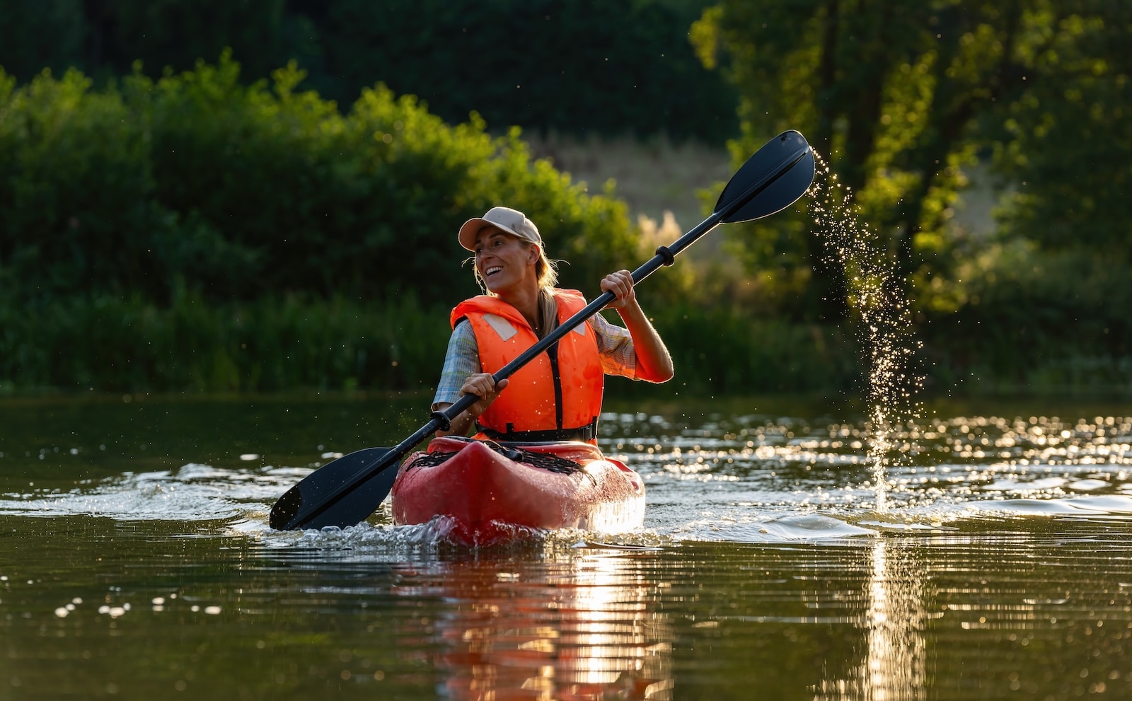 Woman paddling in a kayak along the Green River Gorge NC.