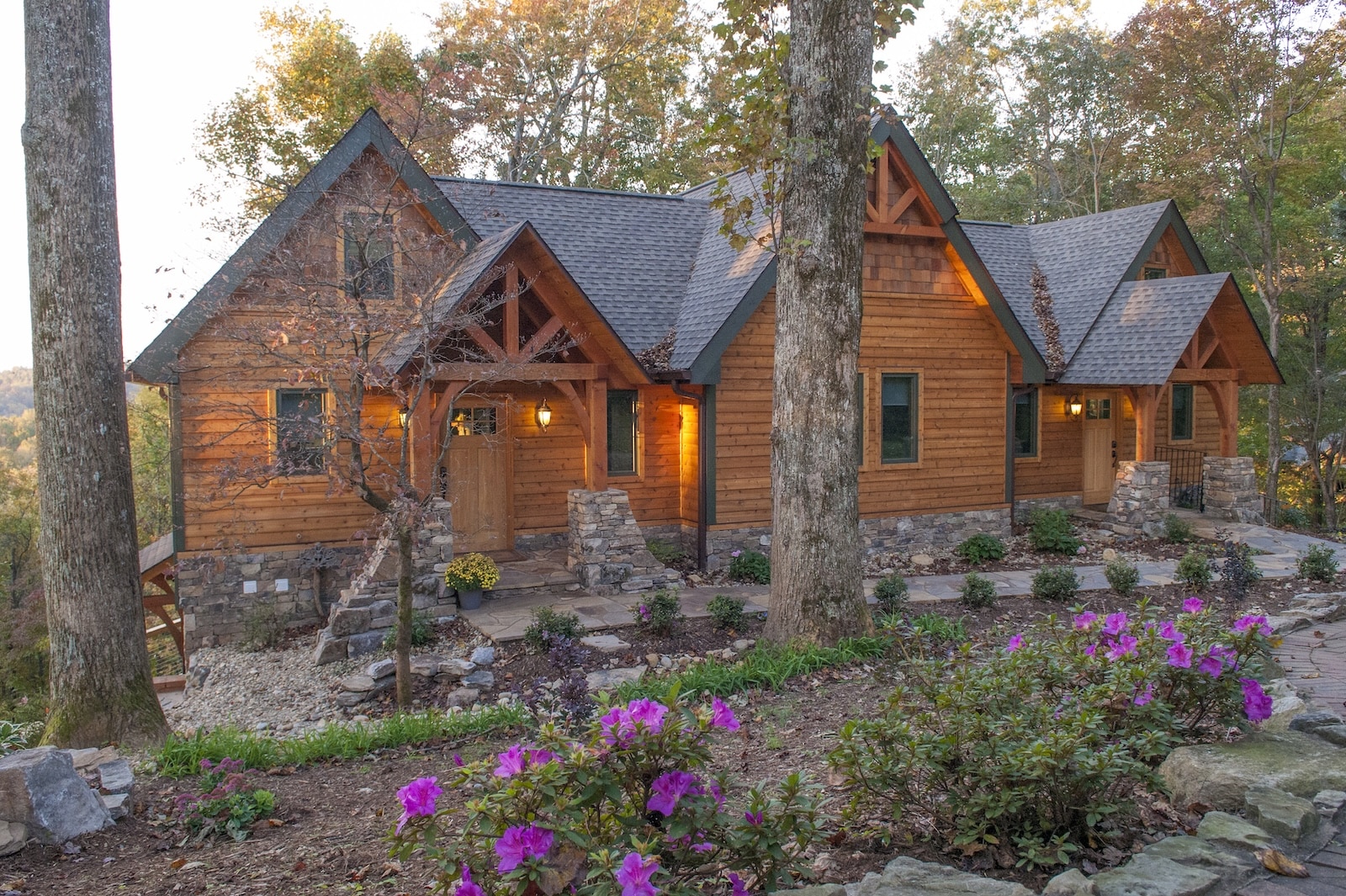 A cabin surrounded by trees and flowers, part of the accommodations at the best Bed and Breakfast NC mountains.
