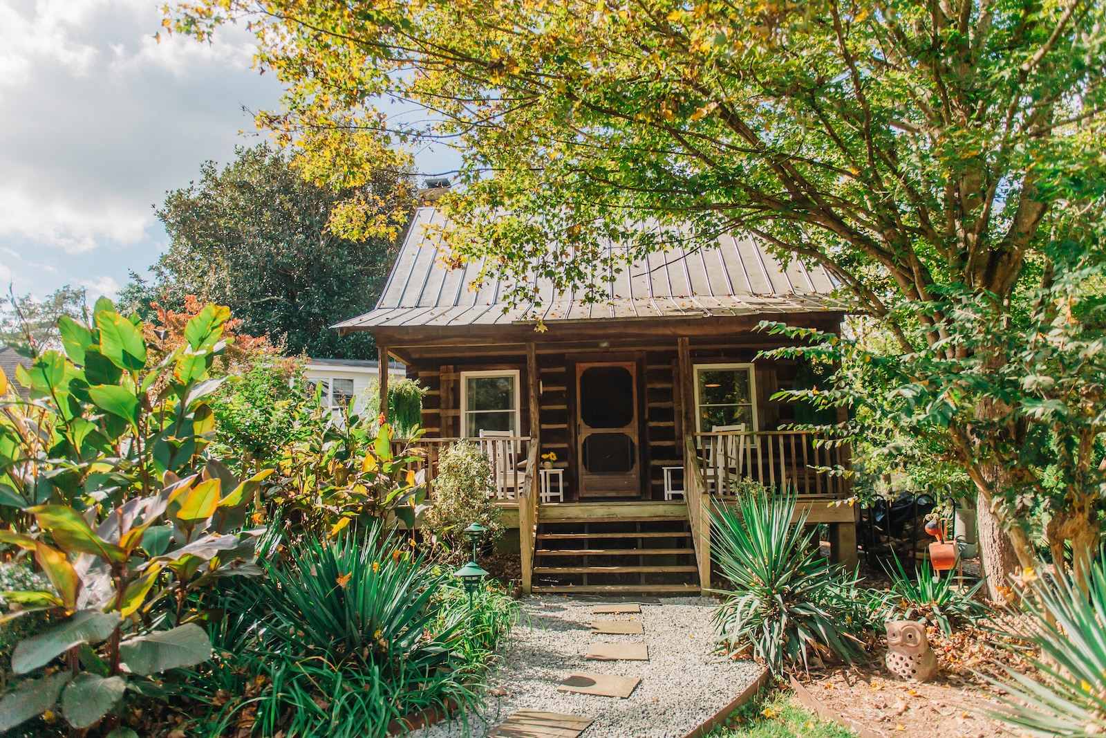 A log cabin surrounded by fall foliage, what you'll find at a romantic Bed and Breakfast North Carolina couples love.