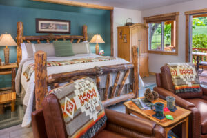 Green Leaf Cabin bed and seating area at Carson Ridge Luxury Cabins