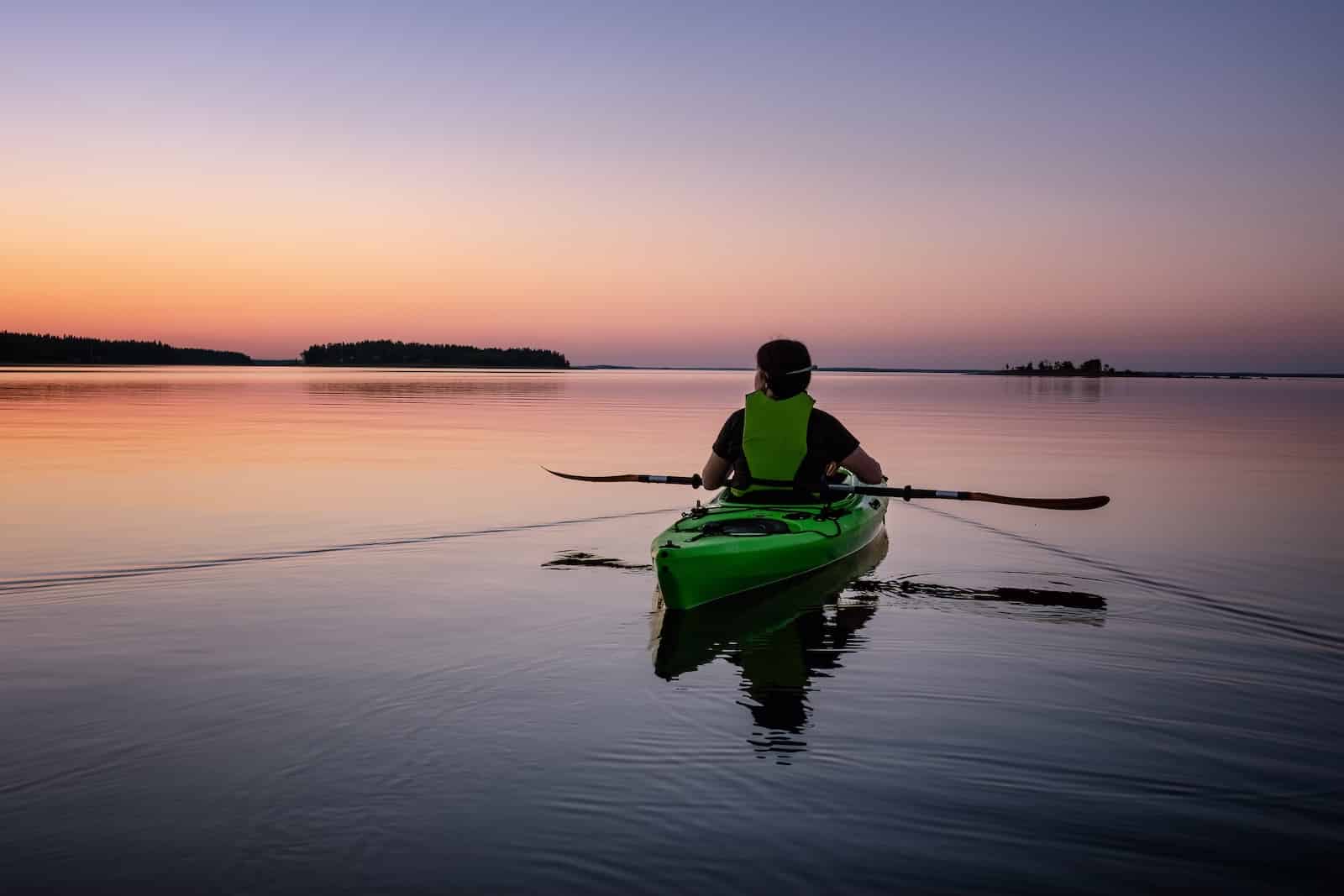 Kayaking in the San Juan Islands is such a wonderful adventure, this woman is enjoying a sunrise from the calm waters