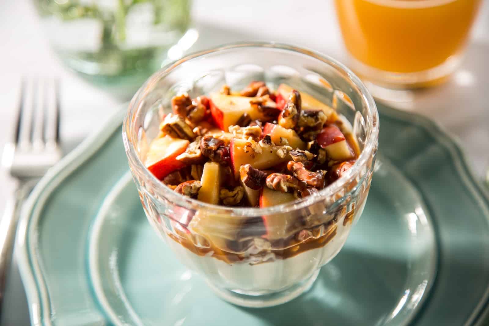A yogurt parfait with berries and nuts in a glass bowl at one of the best weekend getaways in Wisconsin.
