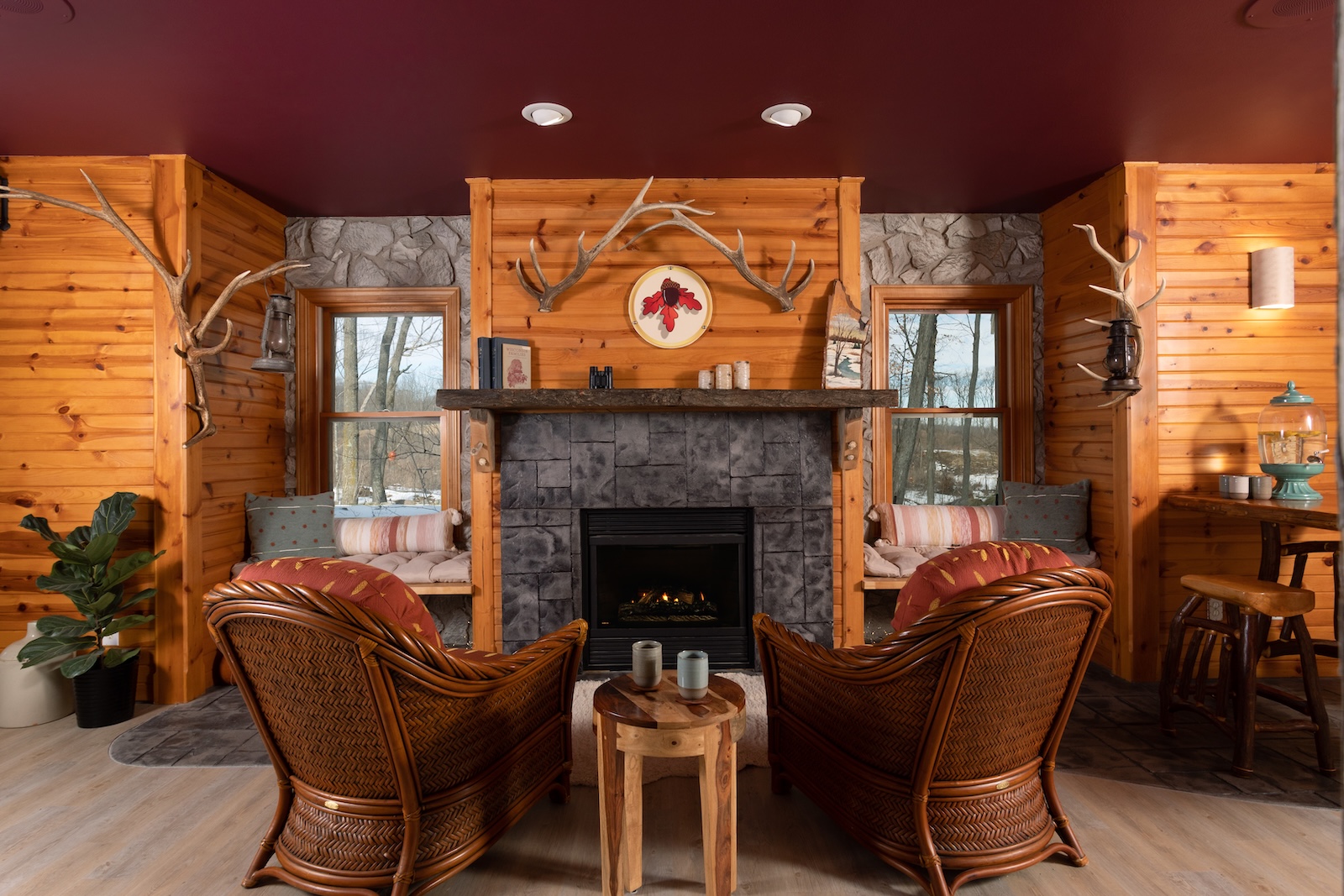 Two chairs in front of a fireplace next to windows at a spa at the best Bed and Breakfast in Wisconsin.