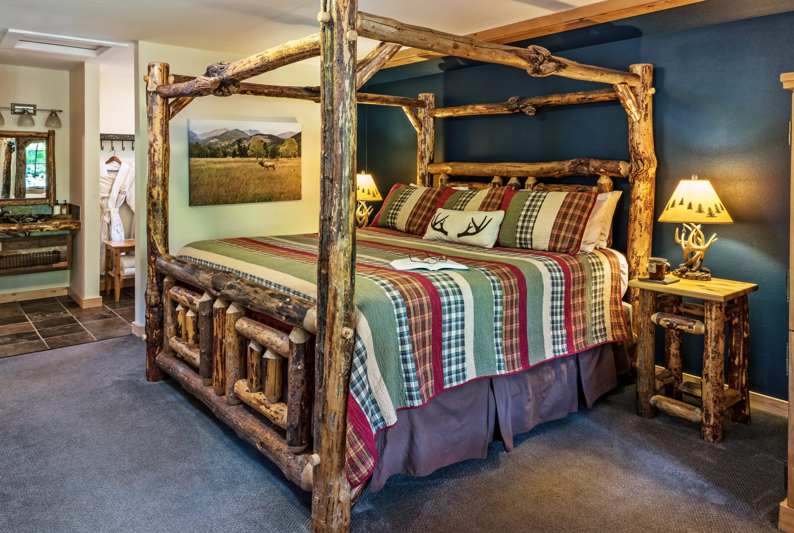 Elk Cove Cabin at our Hood River Cabins features log bed, fireplace and seating area
