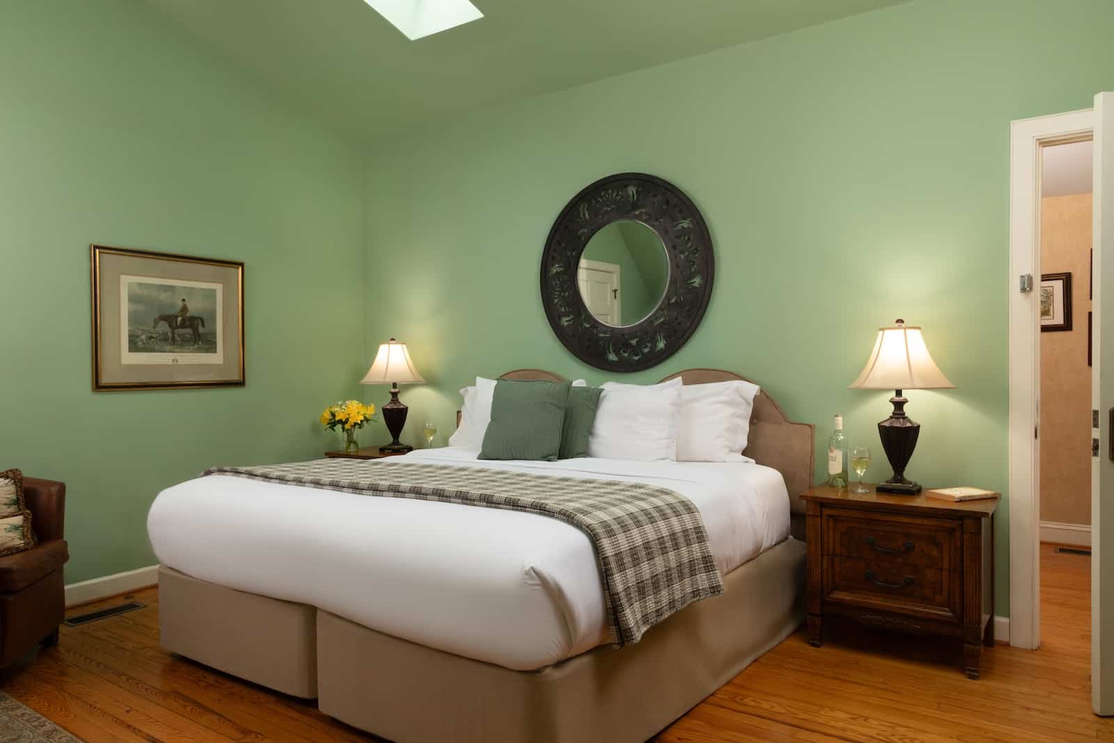 A room at a bed and breakfast in Maryland complete with a queen bed and hunt-themed art.